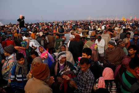 Devotees arrive to take a holy dip at Sangam, the confluence of the Ganges, Yamuna and Saraswati rivers, during "Kumbh Mela", or the Pitcher Festival, in Prayagraj, previously known as Allahabad, India, January 14, 2019. REUTERS/Danish Siddiqui