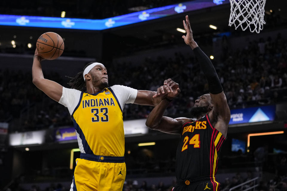 Indiana Pacers center Myles Turner (33) shoots over Atlanta Hawks forward Bruno Fernando (24) during the second half of an NBA basketball game in Indianapolis, Sunday, April 14, 2024. (AP Photo/Michael Conroy)