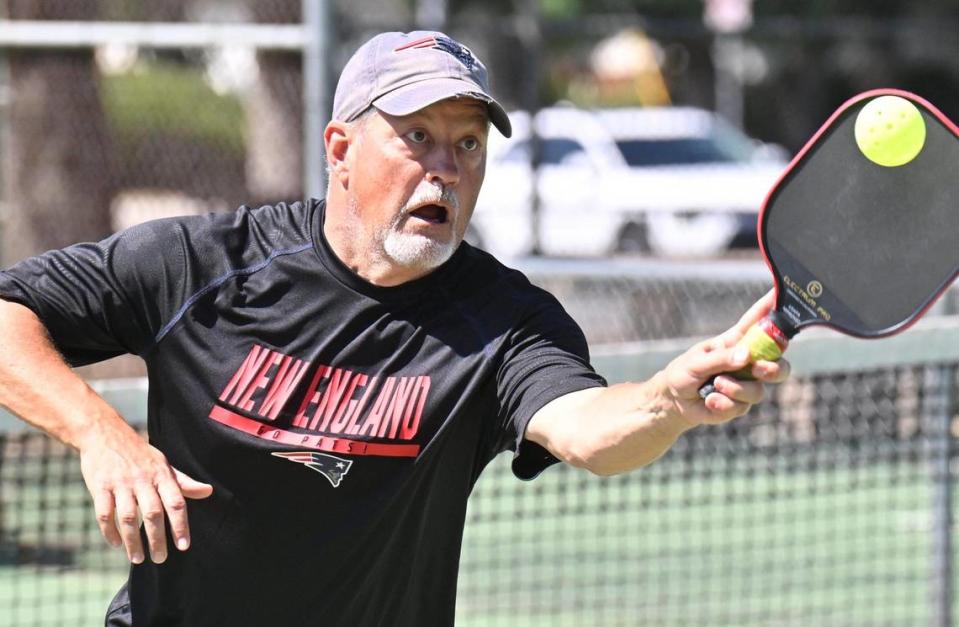 Brian Werner reaches to return the ball in a pickleball game at Rotary East Park Wednesday morning, June 21, 2023 in Fresno. Although surrounding towns have dedicated pickleball courts, Fresno and Clovis area fans of the game must share the use of tennis courts with added pickleball lines.