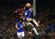 Everton's Nikica Jelavic (R) challenges Queens Park Rangers Joey Barton during their English FA Cup soccer match at Goodison Park in Liverpool, northern England January 4, 2014. REUTERS/Darren Staples (BRITAIN - Tags: SPORT SOCCER)