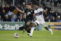 Vancouver Whitecaps forward Cristian Dájome (11) is stopped on a run by Minnesota United defender D.J. Taylor (27) in the first half of an MLS soccer game Saturday, March 25, 2023, in St. Paul, Minn. (AP Photo/Andy Clayton-King)
