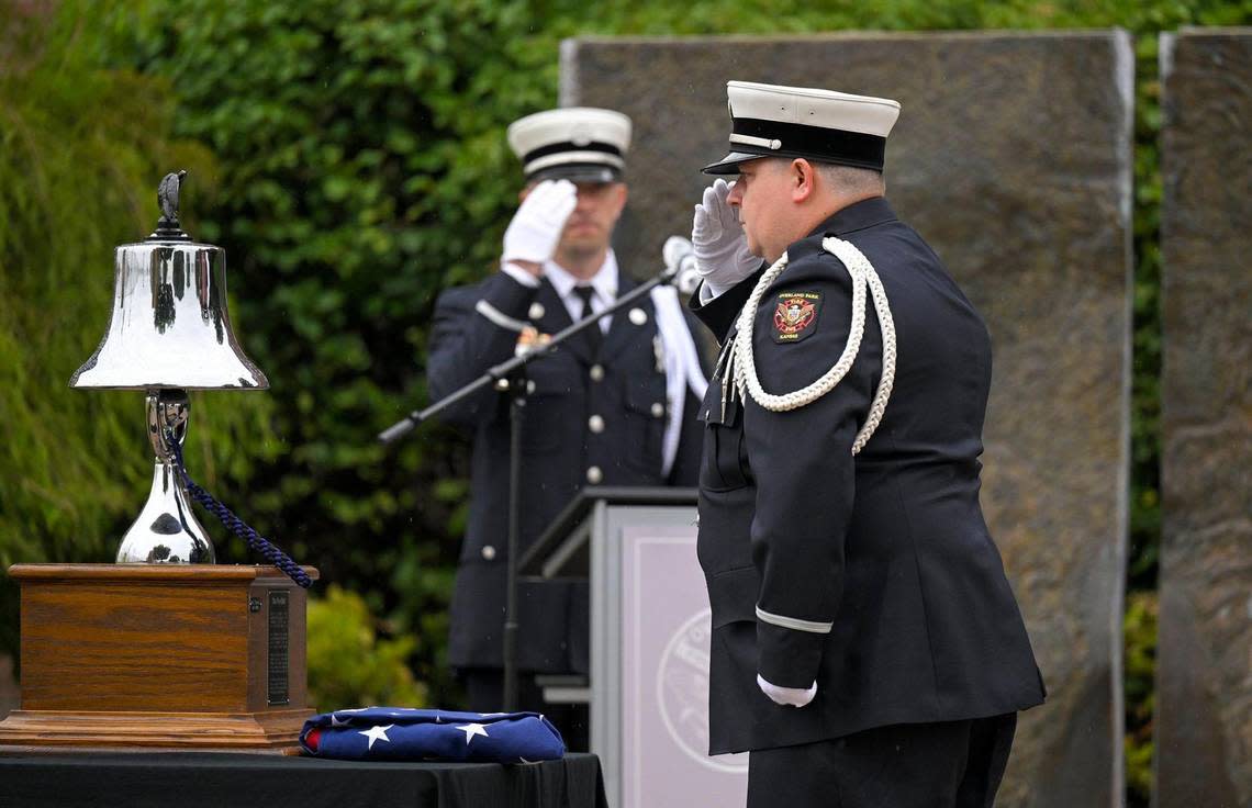 Members of the Overland Park Fire Department including honor guard coordinator, David Hollandsworth, left, and fire medic Michael Manns saluted during the commemoration of the 22nd anniversary of the 9/11 terrorist attacks on America during a solemn ceremony held at 9/11 Memorial in Overland Park on Monday, Sept. 11, 2023. The ceremony at the Overland Park Fire Training Center paid tribute to those lost who lost their lives on September 11, 2001.