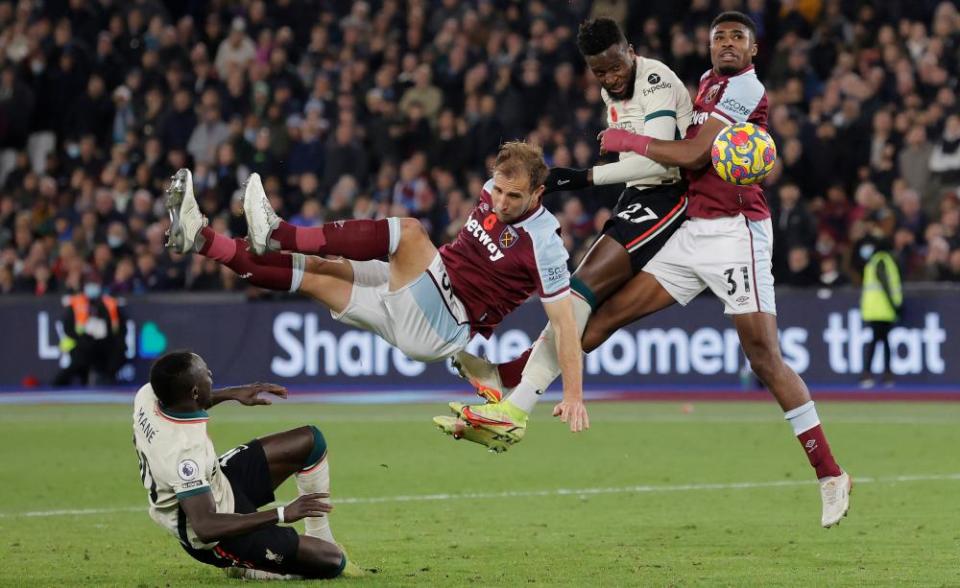 Divock Origi of Liverpool misses a late chance to equalise as Craig Dawson and Ben Johnson defend for West Ham at the London Stadium.