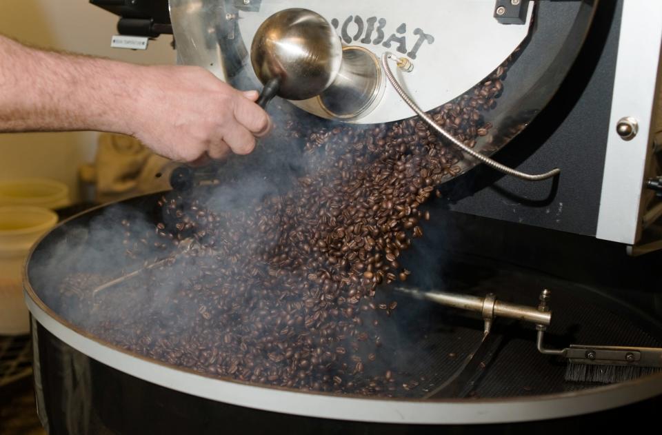 Freshly roasted coffee beans are released from the roaster at the  Cactus Creek Gourmet Coffee Roasters in Aberdeen.