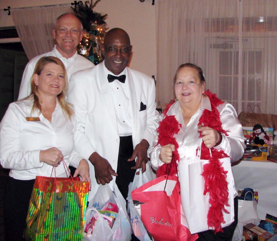 Joyce (third from left) is shown during one of his annual Birthday Bashes, held to benefit Beaches Emergency Assistance Ministry.