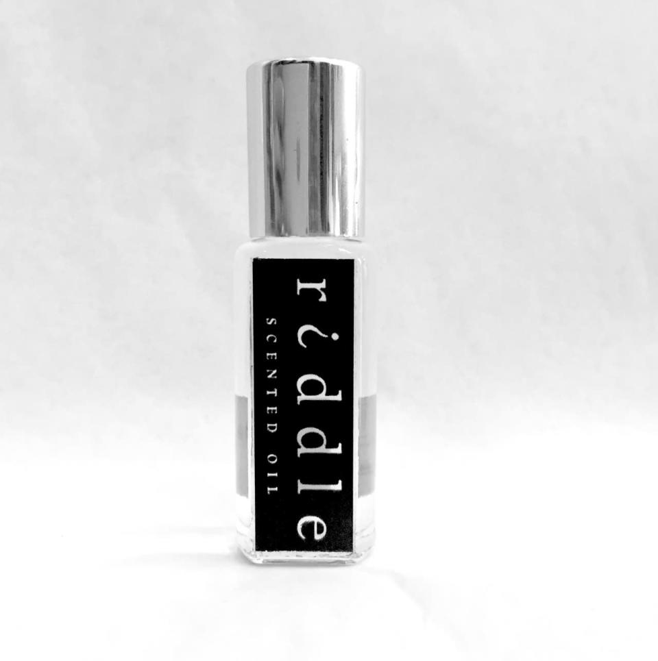 The Fragrance: Riddle Oil;  Based on the science that we’re all attracted to each other’s smell, Riddle Scented Oil is a pheromone fragrance that works with your body’s natural chemistry. Once applied, it develops a scent unique to you, blossoming with the heat of your own body.