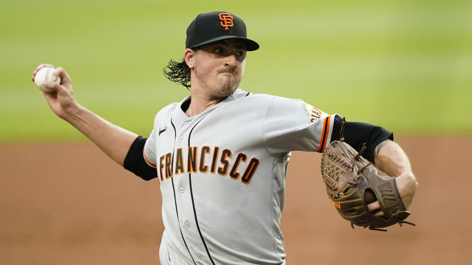 San Francisco Giants pitcher Kevin Gausman works in the first inning of a baseball game against the Atlanta Braves Friday, Aug. 27, 2021, in Atlanta. (AP Photo/John Bazemore)