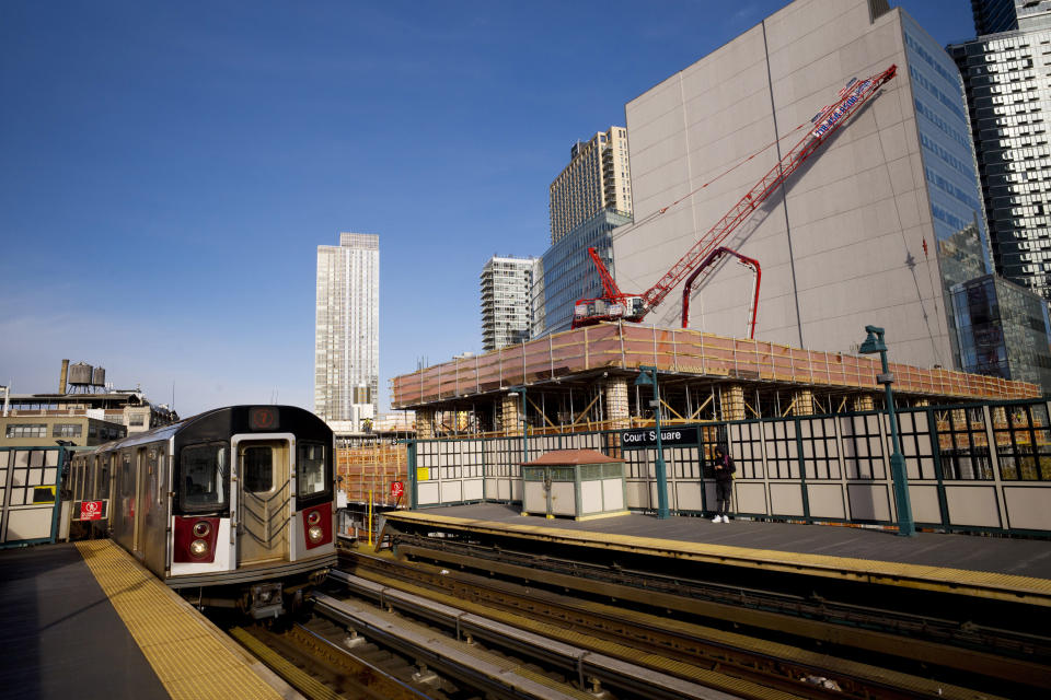 In this Wednesday, Nov. 7, 2018, photo, a construction crane is perched on the site of Court Square City View Tower adjacent to the Court Square Number 7 subway station in Long Island City in the Queens borough of New York. When complete, the 963-foot residential tower will house 774 apartments. (AP Photo/Mark Lennihan)