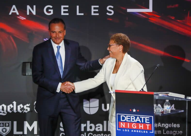 Los Angeles, CA - September 21: Rep. Karen Bass, right, and developer Rick Caruso greet each other following the Los Angeles mayoral debate ahead of the Nov. 8 general election at the Skirball Cultural Center in Los Angeles, Wednesday, Sept. 21, 2022. The Los Angeles Times, Fox 11 LA, Univision 34, KPCC, the Skirball Cultural Center, the Los Angeles Urban League and Loyola Marymount University co-host back-to-back debates with the leading candidates in the L.A. mayoral and L.A. County Sheriff races. Los Angeles County Sheriff debate includes Sheriff Alex Villanueva and retired Long Beach Police Chief Robert Luna. The evening aims to be informative for Angelenos ahead of the Nov. 8 general election, which will include the runoff for the next mayor and sheriff. The debates will be co-moderated by Times Columnist Erika D. Smith and Fox 11 News Anchor Elex Michaelson. Additionally, Univision morning news anchor Gabriela Teissier will join the moderators during the mayoral debate, and Univision evening news anchor Oswaldo Borraez will join the moderators during the sheriff candidates debate. KPCC criminal justice correspondent Frank Stoltze will contribute as well.(Allen J. Schaben / Los Angeles Times)