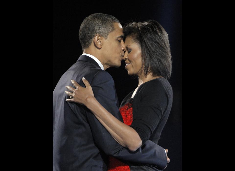 In this Nov. 4, 2008 file photo, President-elect Barack Obama, left, kisses his wife Michelle Obama after addressing supporters at the election night rally in Chicago.  