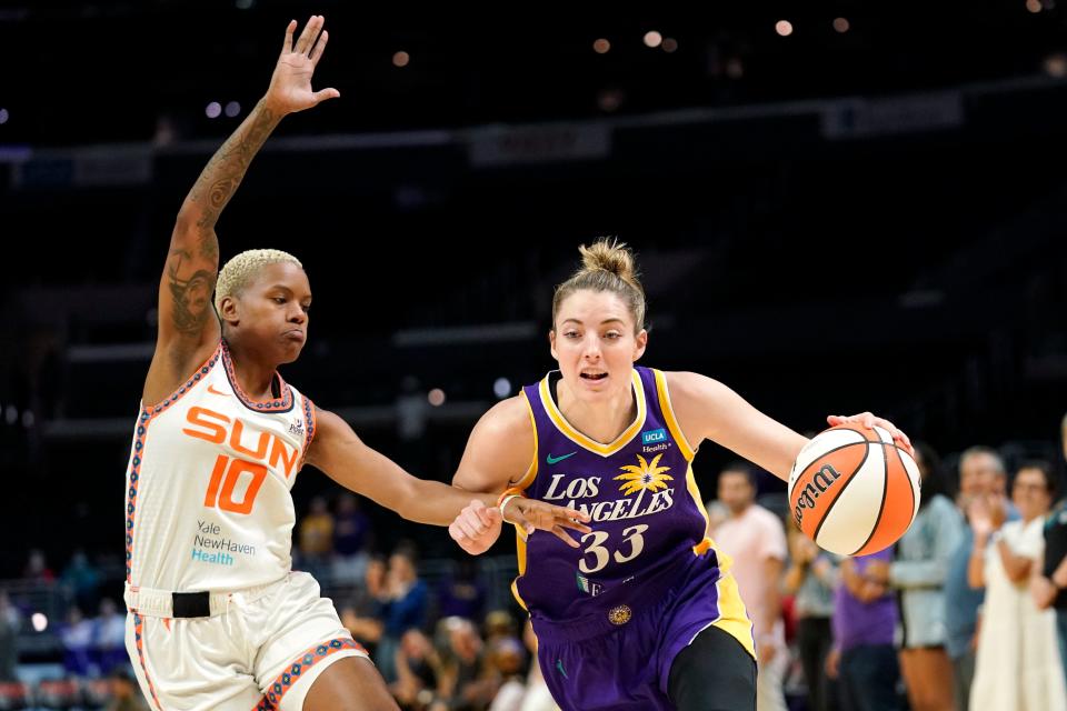 Los Angeles Sparks forward Katie Lou Samuelson, right drives pas Connecticut Sun guard Courtney Williams during the first half of a WNBA basketball game Thursday, Aug. 11, 2022, in Los Angeles. (AP Photo/Mark J. Terrill)