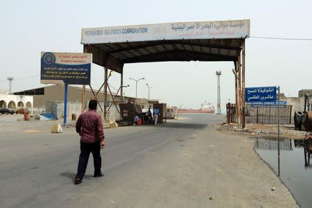 A man walks towards the gate of the Red Sea port of Hodeidah, Yemen June 24, 2018. REUTERS/Abduljabbar Zeyad