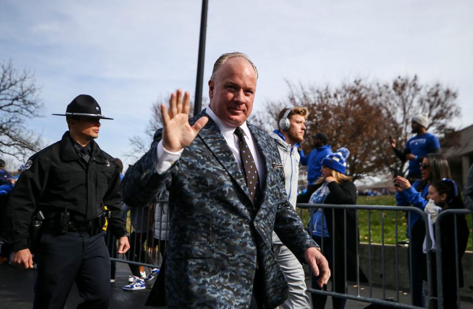 UK head football coach Mark Stoops greets the fans lining the Cat Walk before the game against rival Louisville in Saturday's Governors Cup college football game. Nov. 26, 2022.  