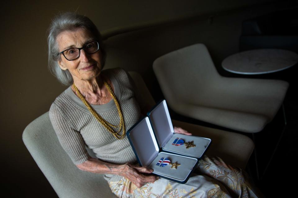 Mary Tyndall Troff poses with her father's WWI medals after they were returned to the family by U.S. Army Brigadier General Richard Miller on Tuesday, Aug. 16, 2022, at Seventy-Six Restaurant in Holland.