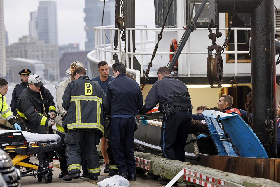 This image provided by NBC10 Boston shows first responders tending to a man on a stretcher Tuesday, Sept. 26, 2023, in Boston, who had fallen overboard from the tanker MTM Dublin in rough seas off Boston. Officials say the crew of a fishing boat recovered a man who had fallen overboard from a tanker and began CPR. The Coast Guard says a mayday from the tanker MTM Dublin went out shortly after 4:30 a.m. The man’s condition is not known. (NBC10 via AP)