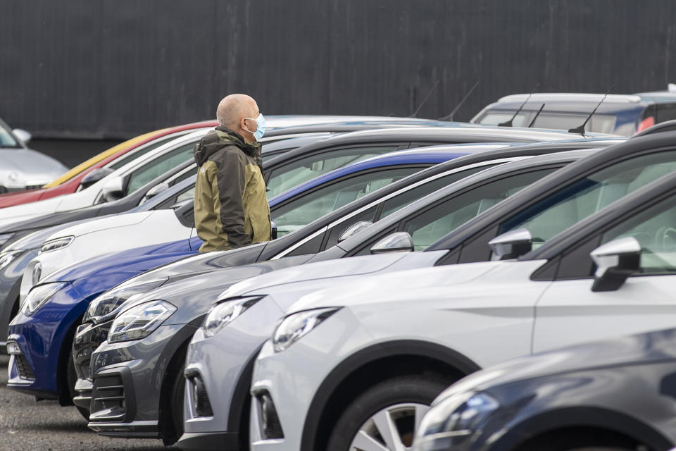 Potential customer walks around Charles Hurst Usedirect used car dealership on Boucher Road in Belfast as restrictions in Northern Ireland ease allowing new and used cars sales.