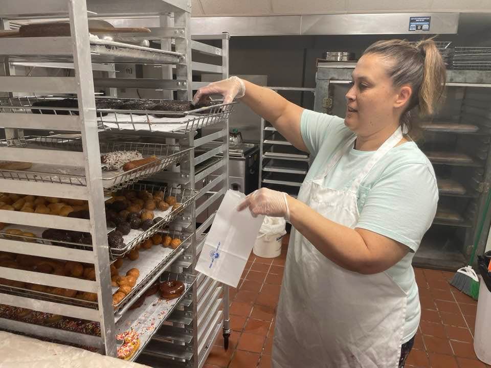 Dixie Donuts owner Jennifer Baker packs some donuts on Wednesday.