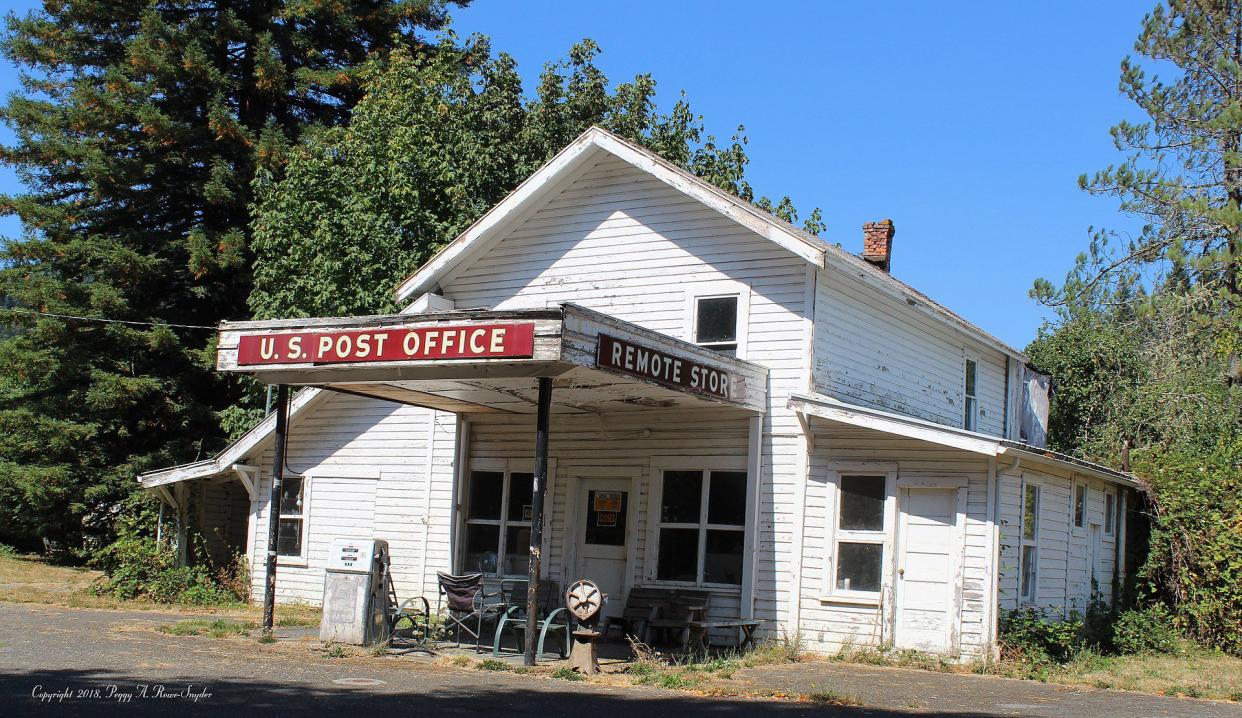 Remote, Coos County, Oregon. Photo of the Remote Post Office, Store, & 76 Gas Station. The last price per gallon as the pump reads is $1.57 a gallon. One house stands to the left of the store/post office/gas station.