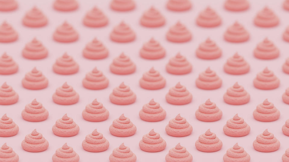 Multiple swirls of pink frosting arranged in a grid pattern on a light background