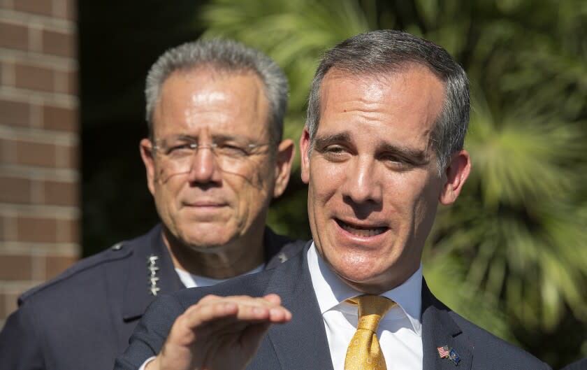 LOS ANGELES, CA-AUGUST 28, 2019: LAPD Chief Michel Moore, left, and Mayor Eric Garcetti are photographed during a press conference in front of the LAPD Southeast Station regarding enforcement efforts in connection with illegal cannabis facilities in the city. (Mel Melcon/Los Angeles Times)