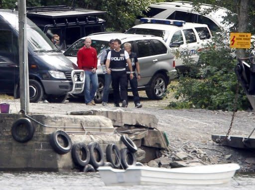 Norwegian extremist Anders Behring Breivik (red jumper) is escorted by police on a return to Utoeya island in August 2011 to explain the details of his shooting massacre. Breivik has pleaded not guilty for his massacre of 77 people in Norway last July in a defiant start to his trial that saw him greet the Oslo courtroom with a far-right salute