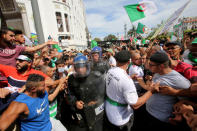 Demonstrators gesture towards police officers during an anti-government protest in Algiers, Algeria May 17, 2019. REUTERS/Ramzi Boudina