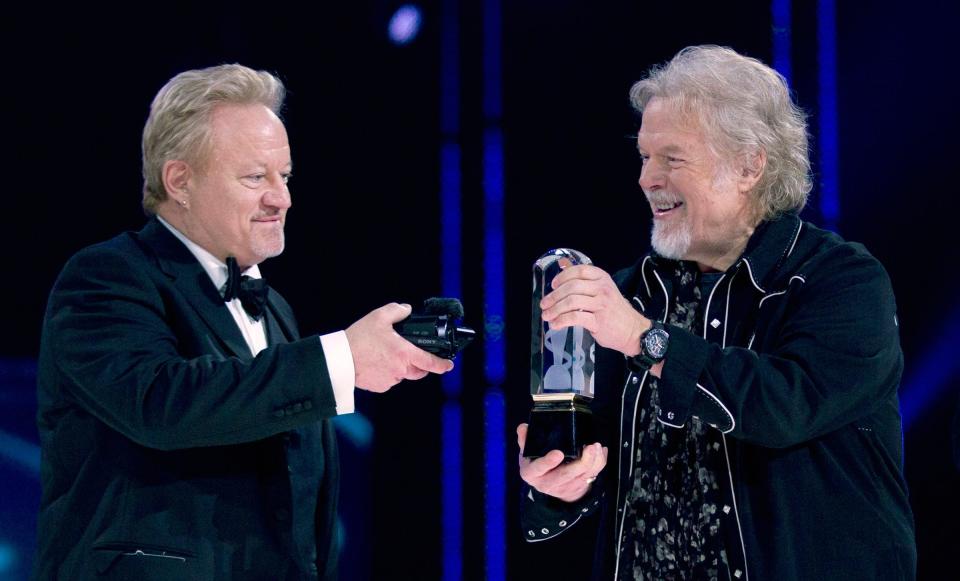 Randy Bachman holds the Juno as Robbie Bachman videotapes a closeup of the trophy after being inducted into the Canadian Music Hall of Fame at the Juno Awards in Winnipeg, Sunday, March 30, 2014. Bachman-Turner Overdrive will perform at Fantasy Springs Resort Casino in Indio, Calif., on Nov. 4, 2023.