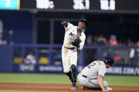 Milwaukee Brewers' Hunter Renfroe (12) is out at second as Miami Marlins second baseman Jazz Chisholm Jr. throws to first during the sixth inning of a baseball game Saturday, May 14, 2022, in Miami. Tyrone Taylor was safe at first. (AP Photo/Lynne Sladky)