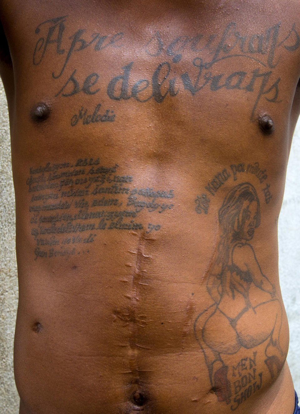 <p>The tattoos on the chest and abdomen of a prisoner incarcerated are shown at the National Penitentiary in downtown Port-au-Prince, Haiti, Feb. 13, 2017. The tattoo on his chest reads in Haitian Creole: “After suffering is deliverance.” (Photo: Dieu Nalio Chery/AP) </p>