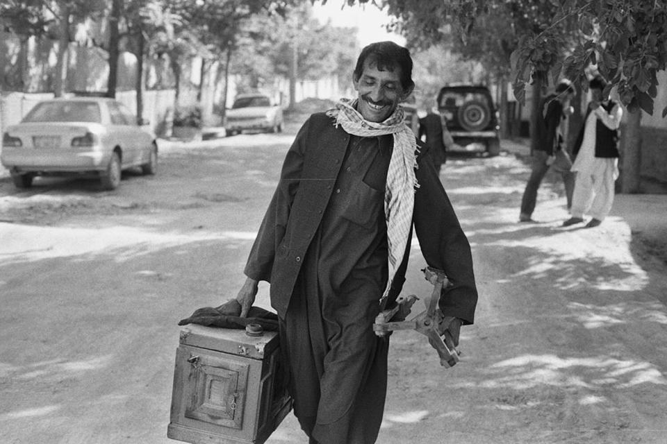 Qalam Nabi walking with his camera.