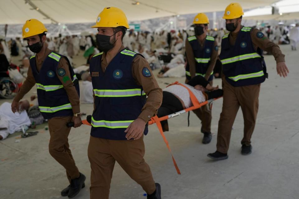 Paramedics carry a Muslim pilgrim for a medical check after he fell due to heatstroke in Mina, near the holy city of Mecca, Saudi Arabia, on Sunday, June 16, 2024 (AP)
