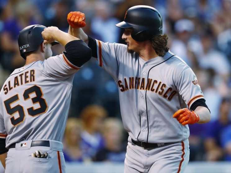 Jeff Samardzija (right) bashes forearms with teammate Austin Slater after his impressive home run. (AP)