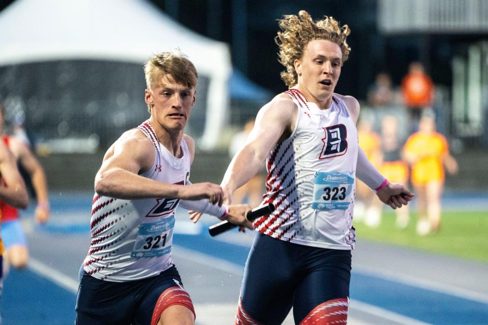 Ballard's Eli Rouse hands the baton off to Chance Lande in the 4x400 meter relay during the Drake Relays at Drake Stadium on Saturday, April 27, 2024, in Des Moines.