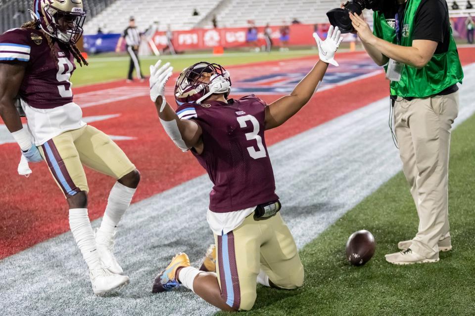 Michigan Panthers running back Reggie Corbin (3) celebrates a long touchdown run against the Philadelphia Stars during the first half at Protective Stadium. Michigan Panthers wide receiver Ray Bolden (9) is also in frame.