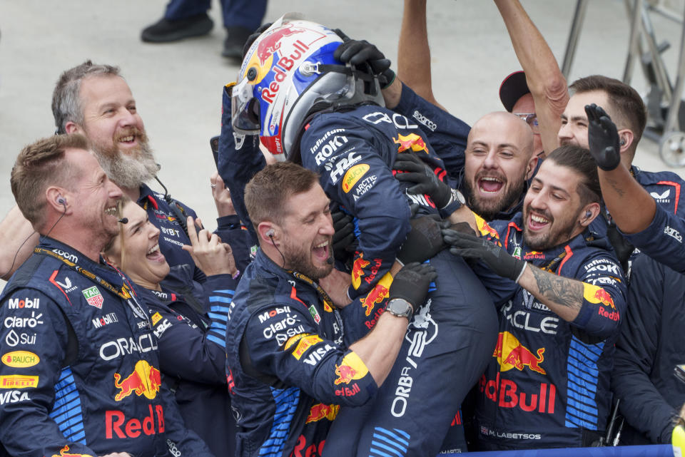 Red Bull Racing driver Max Verstappen, center top, of the Netherlands, celebrates with his crew after his victory at the Formula 1 Canadian Grand Prix auto race in Montreal, Sunday, June 9, 2024. (Paul Chiasson/The Canadian Press via AP)