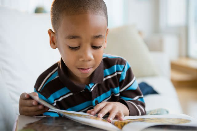 <p>Getty</p> A child reads a book