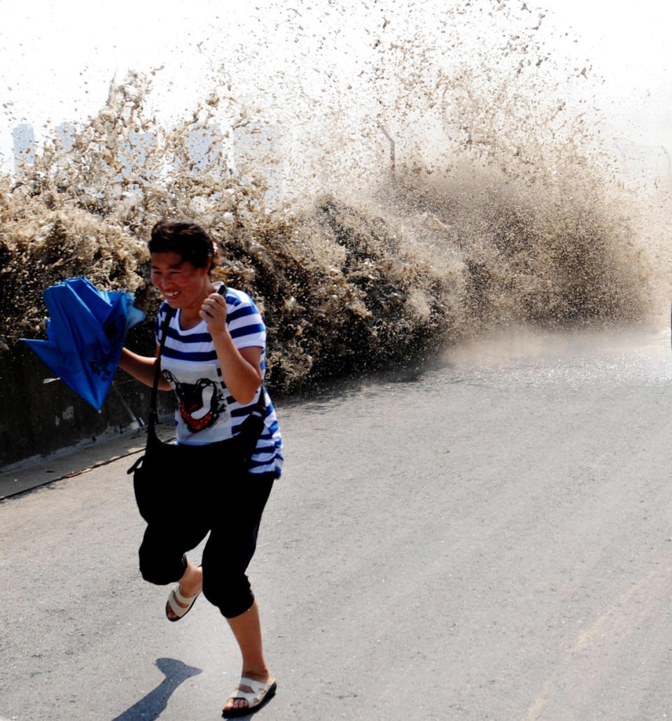 A spectator runs from the advancing tide in China.