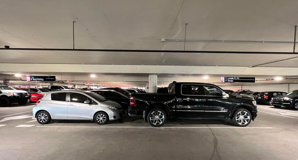 A photo of a black Ram truck taking up too much space at the Chadstone shopping centre carpark in Melbourne.