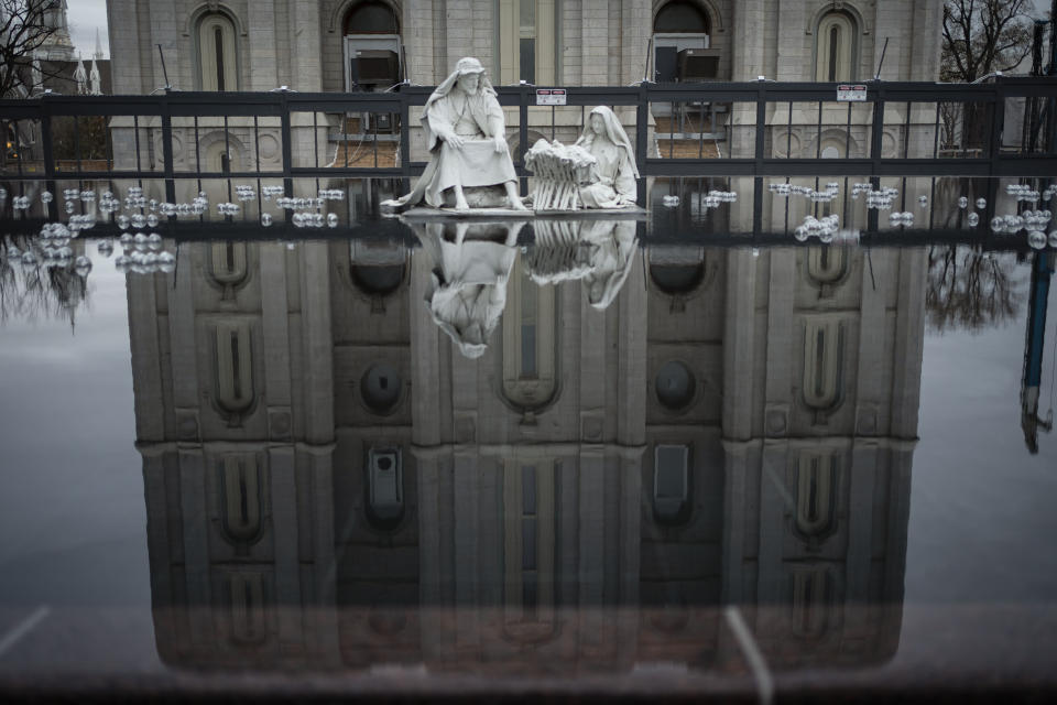 The Salt Lake Temple of The Church of Jesus Christ of Latter-day Saints is seen in a reflection in Salt Lake City, Sunday, Nov. 15, 2020. While the church has traditionally been overwhelmingly conservative and Republican, today there's also an increasingly large strain of liberal members. The church has also begun to directly address its history of racism, including a ban on Black priests that it lifted four decades ago. (AP Photo/Wong Maye-E)