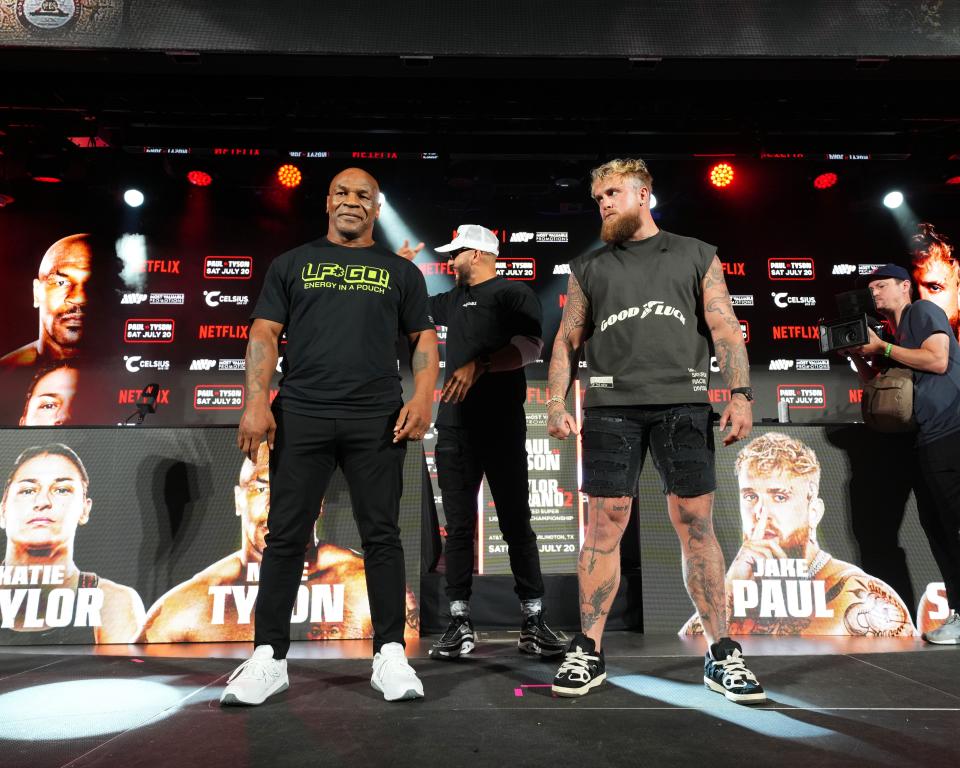 ARLINGTON, TEXAS - MAY 16: (L-R) Mike Tyson, Nakisa Bidarian and Jake Paul pose onstage during the Jake Paul vs. Mike Tyson Boxing match Arlington press conference at Texas Live! on May 16, 2024 in Arlington, Texas. (Photo by Cooper Neill/Getty Images for Netflix)