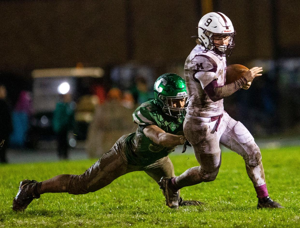 Mishawaka's Chaz Hardy gets past Concord's Gabe Mayo during the Mishawaka vs. Concord sectional football game Friday, Oct. 29, 2021 at Concord High School. 
