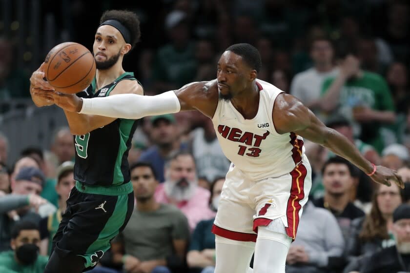 Miami Heat's Bam Adebayo (13) tries to strip the ball from Boston Celtics' Derrick White.