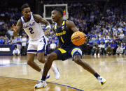 Marquette guard Kam Jones (1) drives to the basket against Seton Hall guard Al-Amir Dawes (2) during the first half of an NCAA college basketball game in Newark, N.J., Saturday, Jan. 21, 2023. (AP Photo/Noah K. Murray)