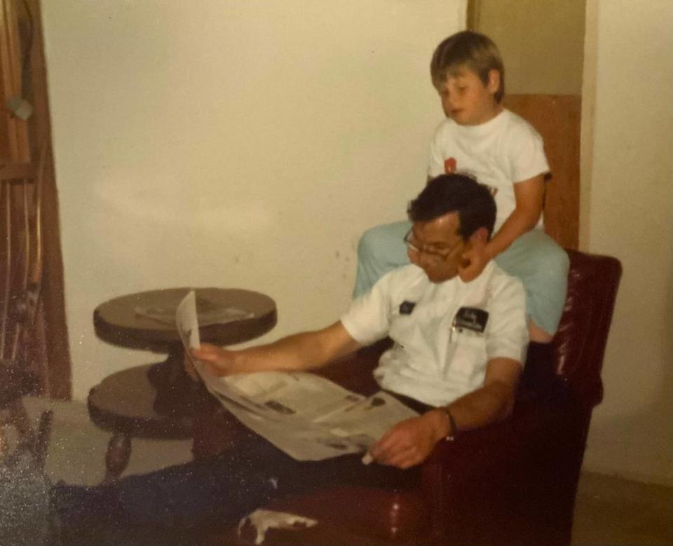 The author’s son, Douglas, reading the newspaper with his dad.