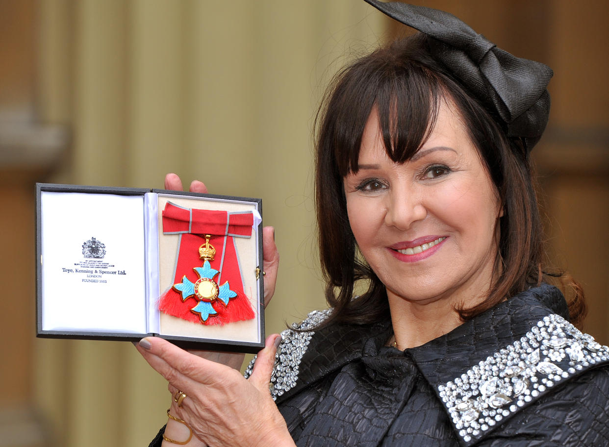 LONDON, ENGLAND - FEBRUARY 13:  Arlene Phillips holds her Commander of the British Empire (CBE) medal after it was presented to her by Queen Elizabeth II at the Investiture Ceremony at Buckingham Palace on February 13, 2012 in London, England.  (Photo by John Stillwell - WPA Pool/Getty Images)