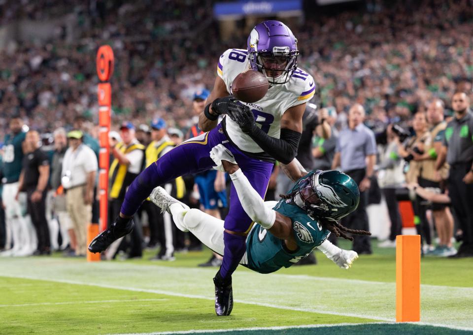 Vikings wide receiver Justin Jefferson fumbles the ball out of bounds in the end zone while being tackled by Eagles safety Terrell Edmunds.