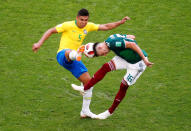 <p>Brazil’s Casemiro in action with Mexico’s Hector Herrera REUTERS/David Gray </p>