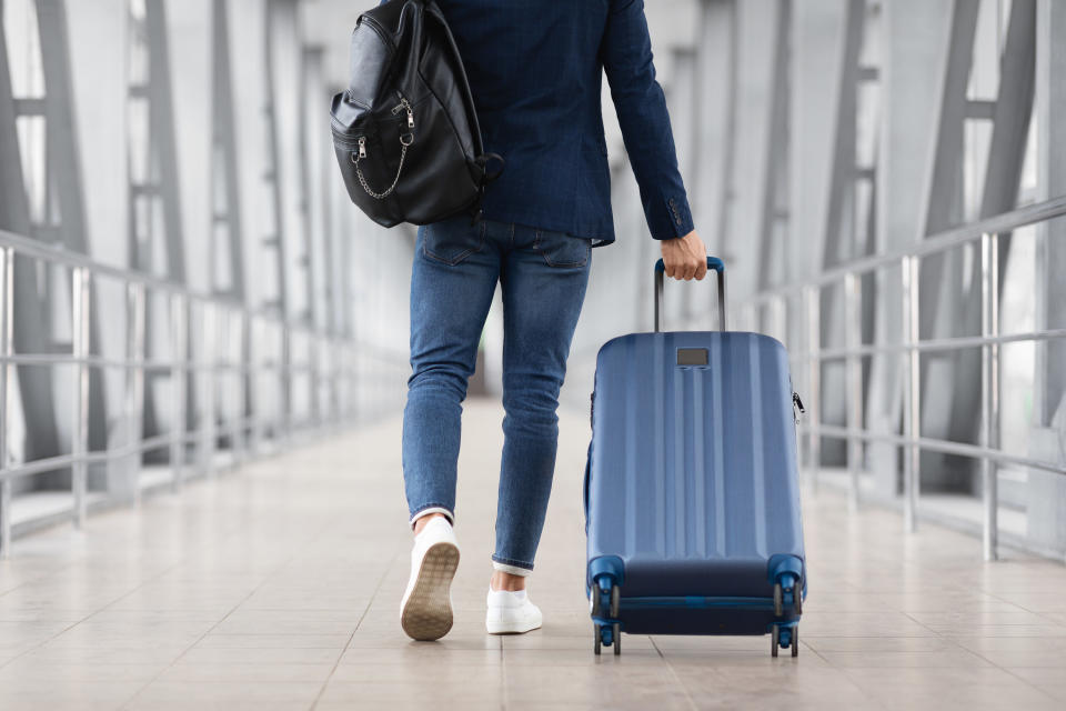 A person walking with luggage