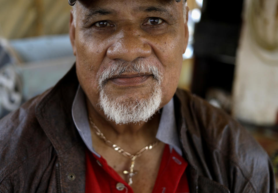 In this Tuesday, April 9, 2019, photo fisherman and former politician Teisina Fuko speaks on his fishing boat in Nuku'alofa, Tonga. China is pouring billions of dollars in aid and low-interest loans into the South Pacific, and even in the far-flung kingdom of Tonga there are signs that a battle for power and influence among much larger nations is heating up and could exact a toll. (AP Photo/Mark Baker)