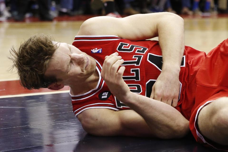 Chicago Bulls forward Mike Dunleavy lies on the court after an injury during the second half of Game 4 of an opening-round NBA basketball playoff series against the Washington Wizards in Washington, Sunday, April 27, 2014. The Wizards defeated the Bulls 98-89. (AP Photo/Alex Brandon)